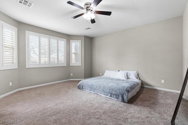 carpeted bedroom with a ceiling fan, visible vents, and baseboards