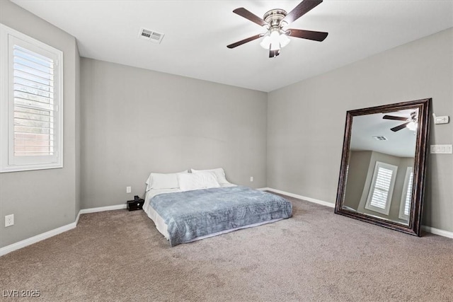 bedroom with carpet floors, multiple windows, and visible vents