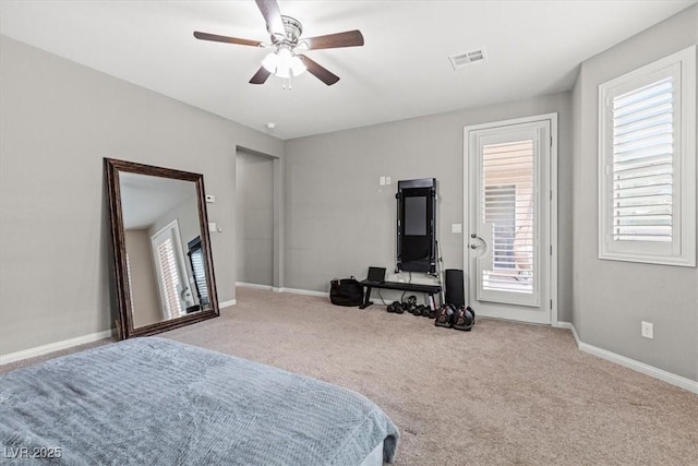 bedroom with carpet floors, access to outside, multiple windows, and visible vents