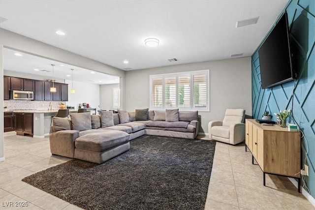 living room with light tile patterned floors, baseboards, visible vents, and recessed lighting