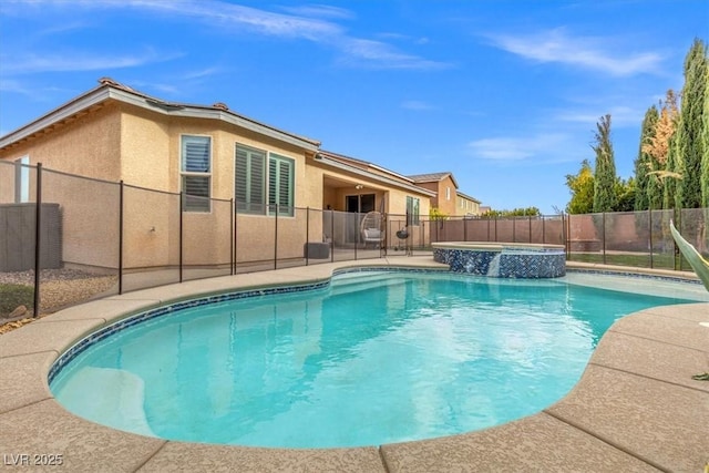 view of pool with a patio area, a fenced backyard, and a pool with connected hot tub