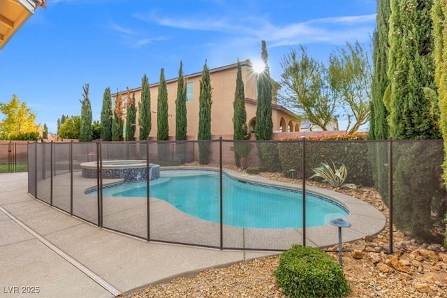 view of pool featuring a patio area, a fenced backyard, and a pool with connected hot tub