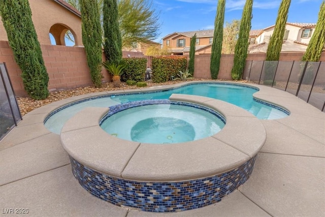 view of swimming pool featuring a fenced backyard and a pool with connected hot tub