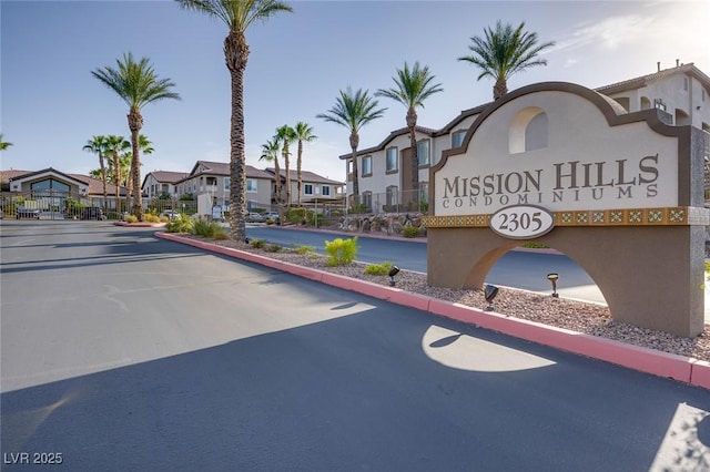 view of road with a residential view, a gated entry, and curbs