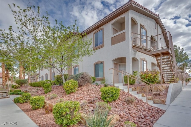 view of front of home featuring stairs and stucco siding