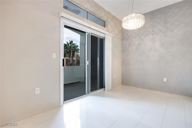 spare room with a chandelier