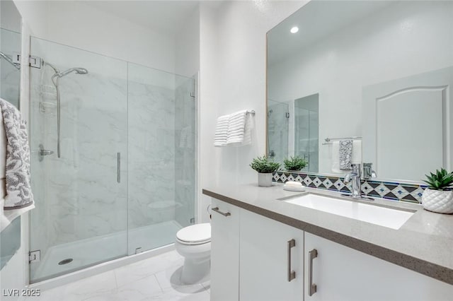 full bathroom featuring a marble finish shower, marble finish floor, toilet, and vanity