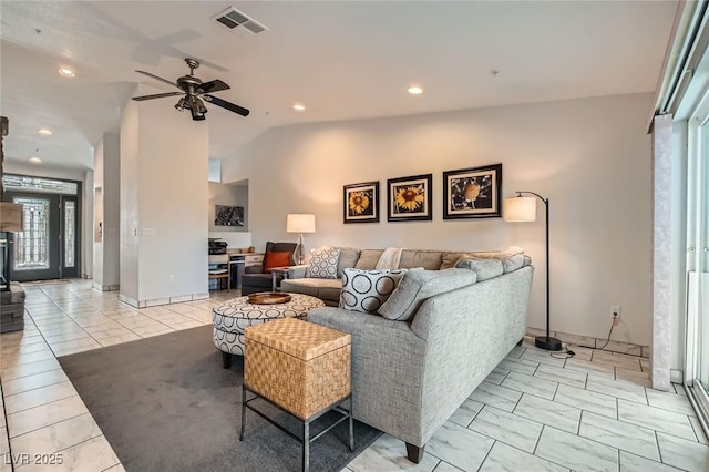 living area featuring visible vents, a ceiling fan, lofted ceiling, a wood stove, and recessed lighting