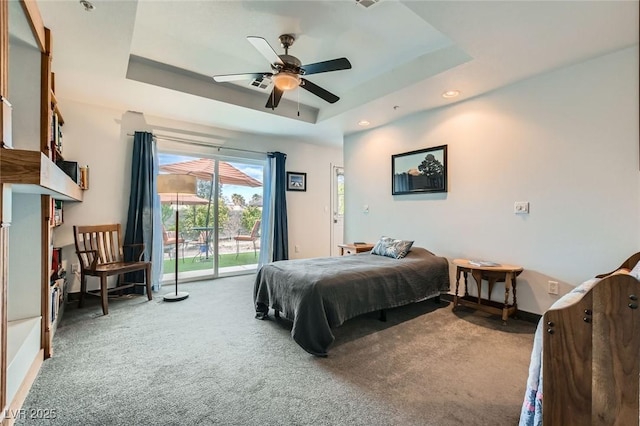 carpeted bedroom with baseboards, ceiling fan, access to exterior, a tray ceiling, and recessed lighting