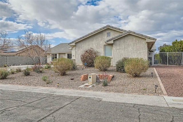 view of front of house featuring fence and stucco siding