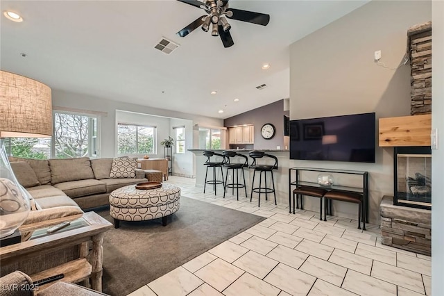 living area with high vaulted ceiling, ceiling fan, visible vents, and recessed lighting