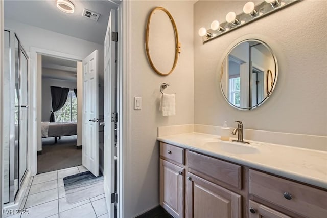 bathroom featuring tile patterned flooring, vanity, and visible vents