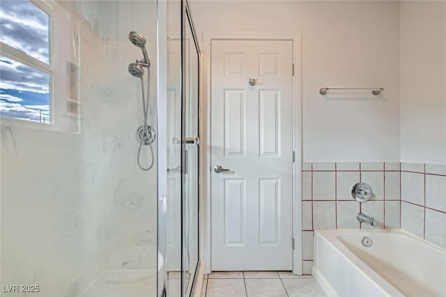 full bath featuring tile patterned flooring, a marble finish shower, and a bath