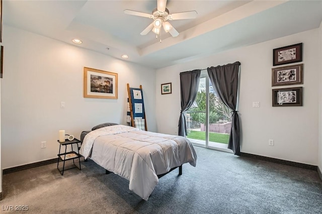 bedroom featuring access to exterior, carpet, a raised ceiling, and baseboards