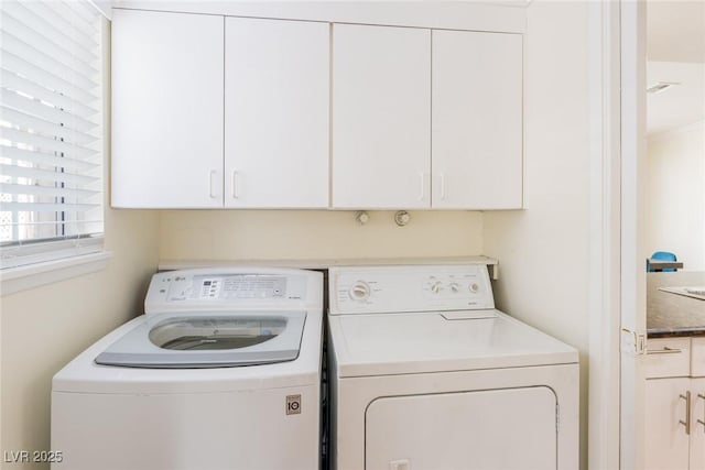 washroom with cabinet space and independent washer and dryer