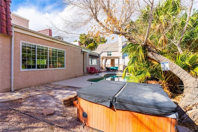 view of patio with an outdoor pool and a hot tub