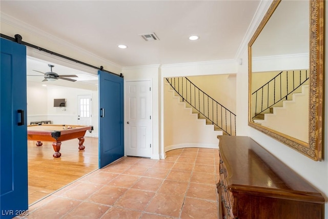 entryway featuring pool table, visible vents, a barn door, ornamental molding, and stairs