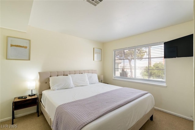 bedroom with light carpet, visible vents, and baseboards