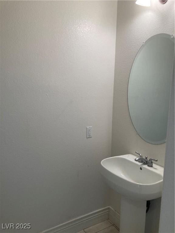 bathroom featuring baseboards and tile patterned flooring