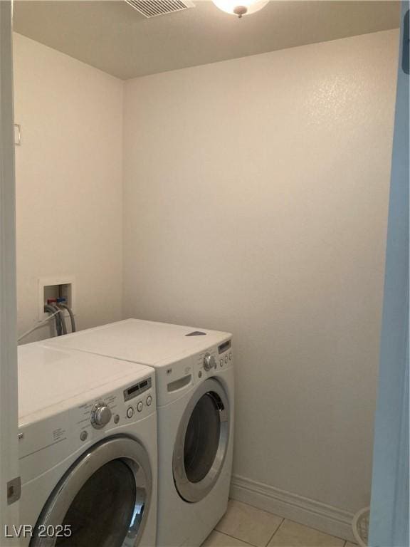 laundry room with light tile patterned floors, baseboards, visible vents, laundry area, and separate washer and dryer