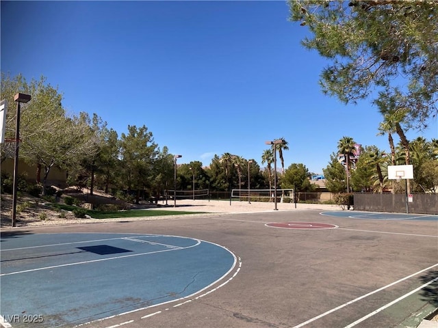 view of basketball court with community basketball court, fence, and volleyball court