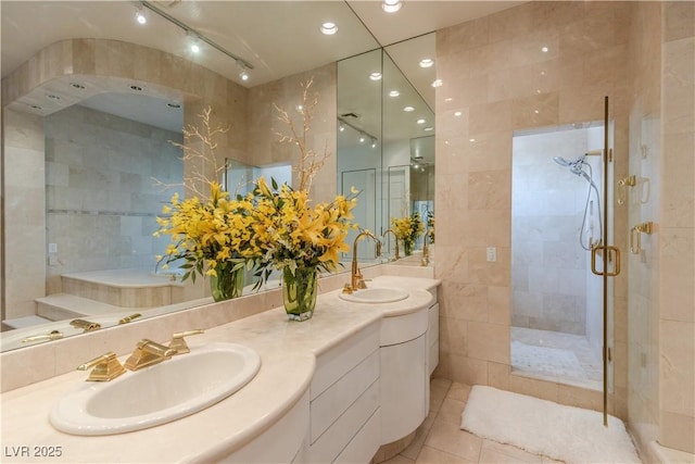 bathroom with tile patterned flooring, recessed lighting, a sink, a shower stall, and double vanity