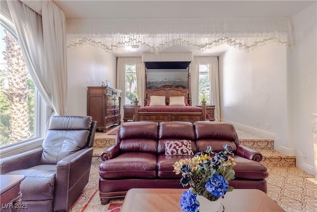 bedroom featuring multiple windows and baseboards