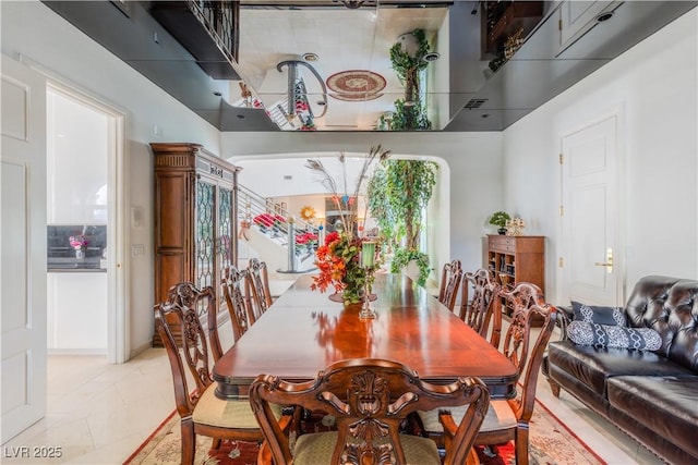 dining area with light tile patterned floors and visible vents