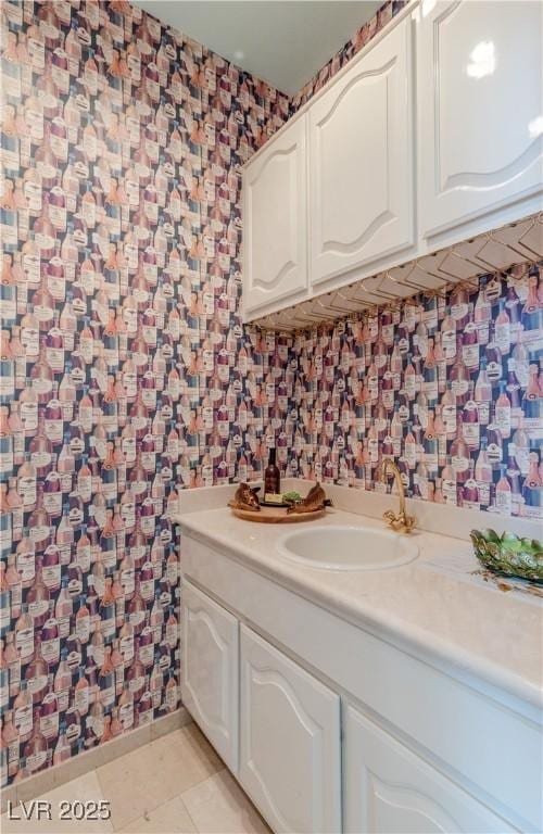 bathroom featuring tile patterned floors, vanity, and wallpapered walls