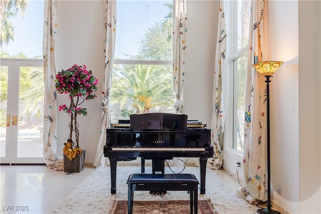 sitting room featuring french doors, tile patterned flooring, and a wealth of natural light