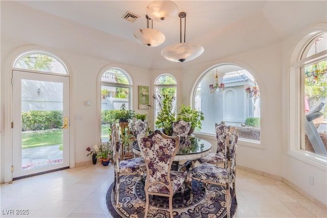 dining room featuring light tile patterned floors, visible vents, and baseboards