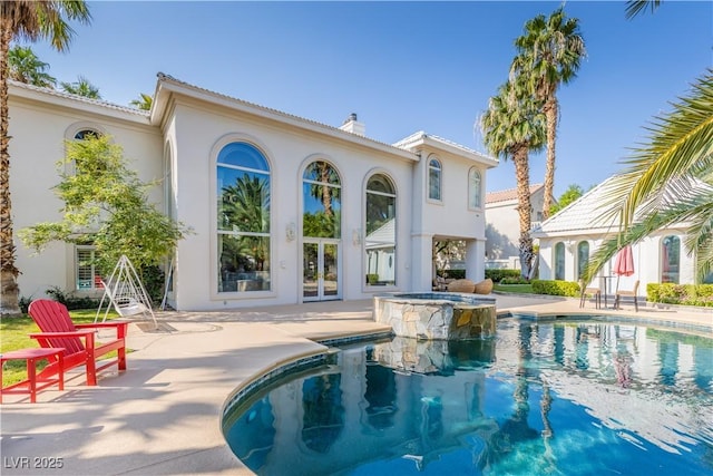 view of pool with a pool with connected hot tub, french doors, and a patio