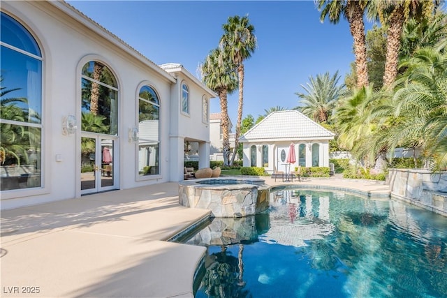 view of swimming pool with a pool with connected hot tub, french doors, and a patio