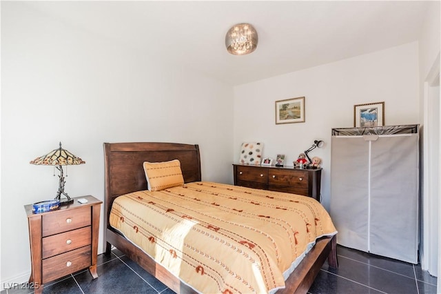 bedroom with dark tile patterned flooring