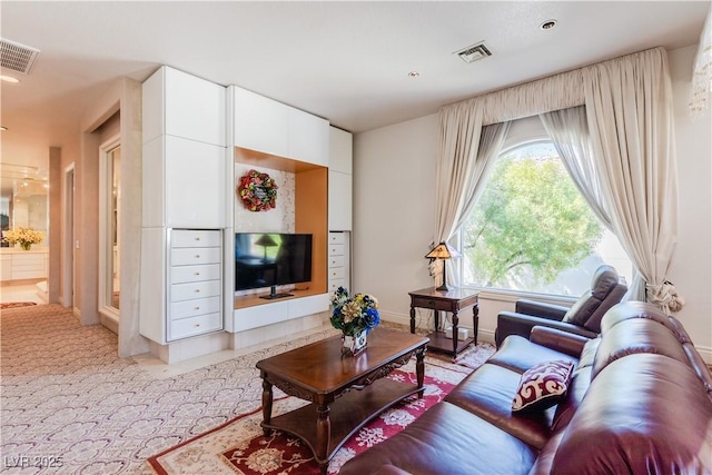 living room with light carpet, baseboards, and visible vents