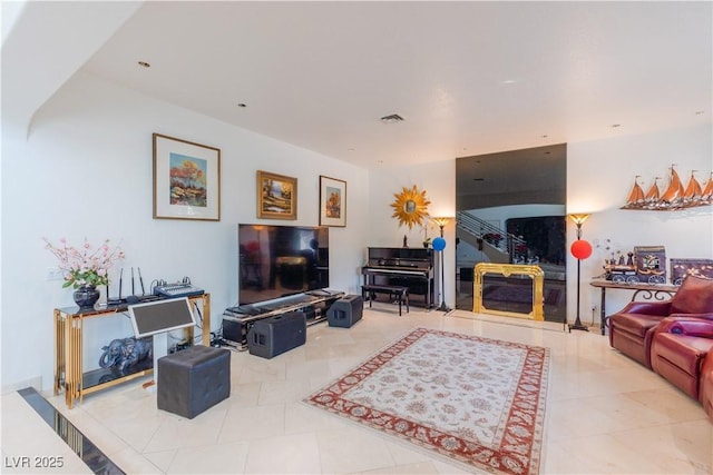 living room featuring tile patterned flooring and visible vents