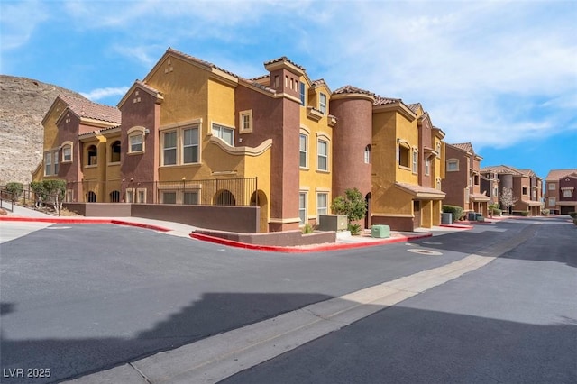 view of property featuring a residential view and central AC