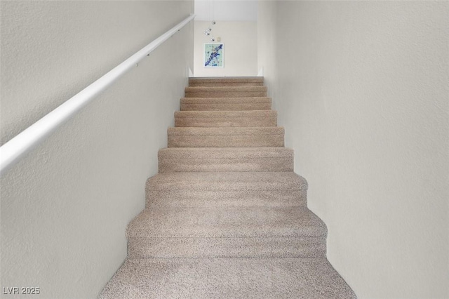 staircase with a textured wall