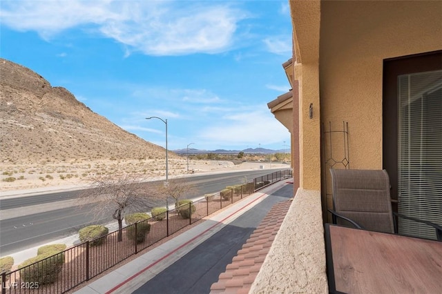 exterior space with a mountain view and a balcony