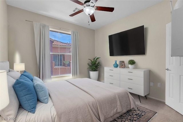 bedroom with light colored carpet, baseboards, and ceiling fan