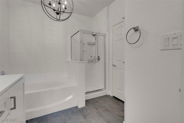 full bath with a bath, a stall shower, vanity, and an inviting chandelier