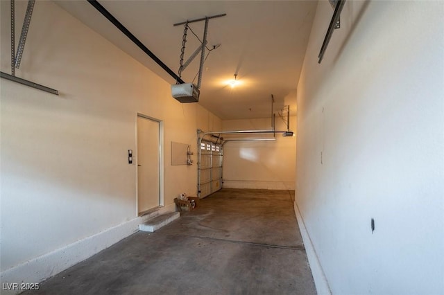 garage with a garage door opener and baseboards