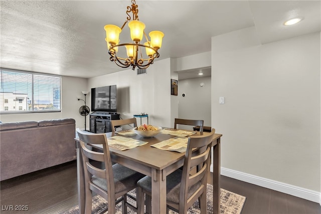 dining space featuring visible vents, baseboards, dark wood-style floors, an inviting chandelier, and a textured ceiling