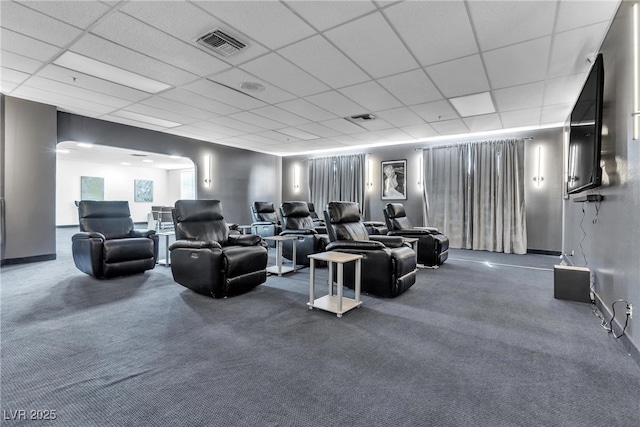 cinema room featuring carpet, visible vents, and a drop ceiling