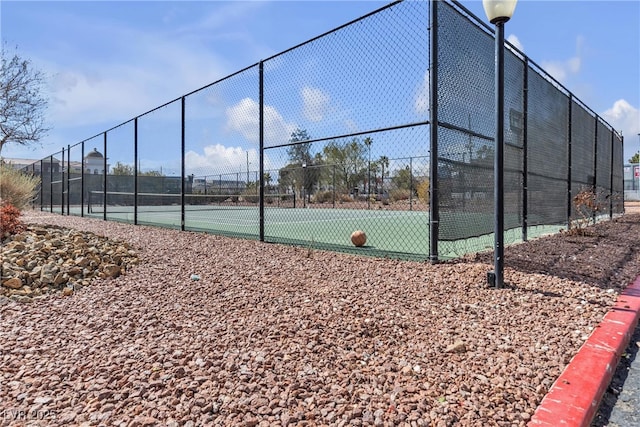 view of sport court with fence