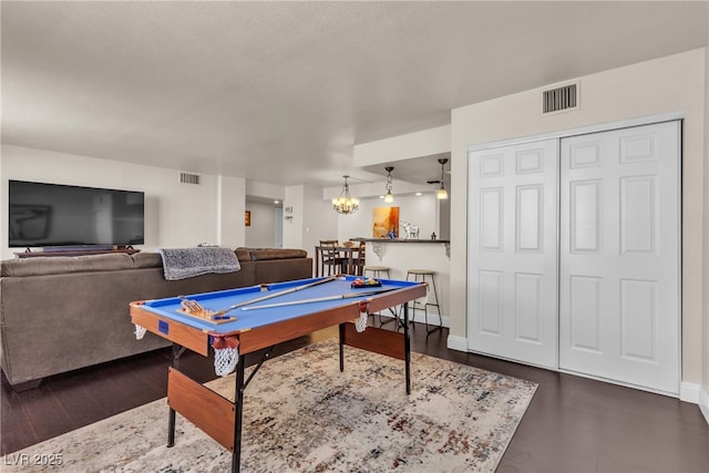 game room featuring dark wood-type flooring, pool table, bar area, and visible vents