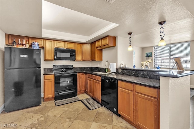 kitchen with a raised ceiling, black appliances, a peninsula, and a sink