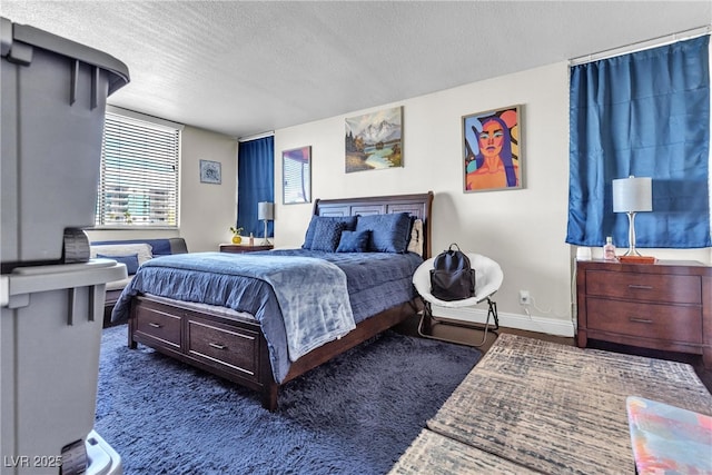 bedroom featuring baseboards and a textured ceiling