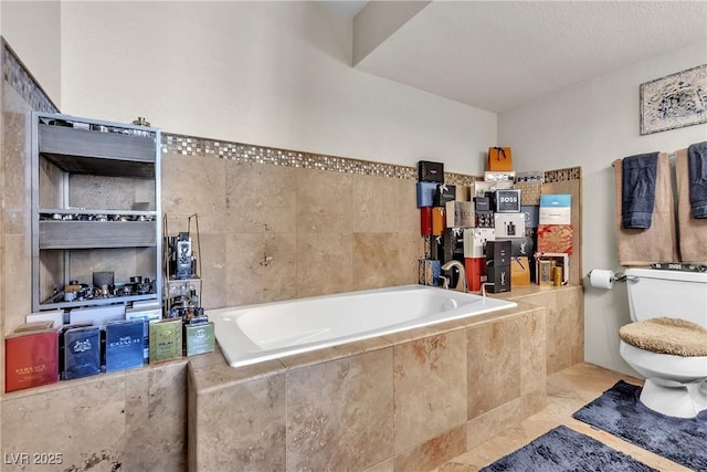 bathroom featuring a bath, toilet, and tile patterned floors