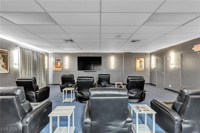 home theater room with baseboards, visible vents, and a drop ceiling